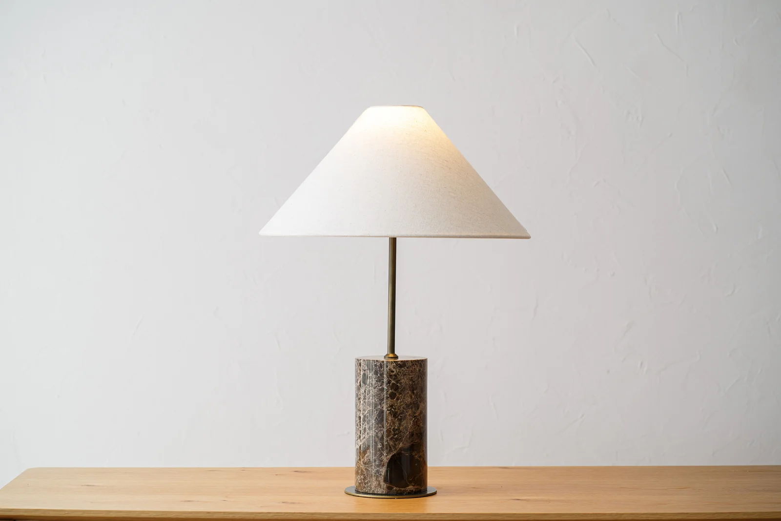 Lámpara de sobremesa de alta decoración con base cilíndrica de mármol y pantalla de lino